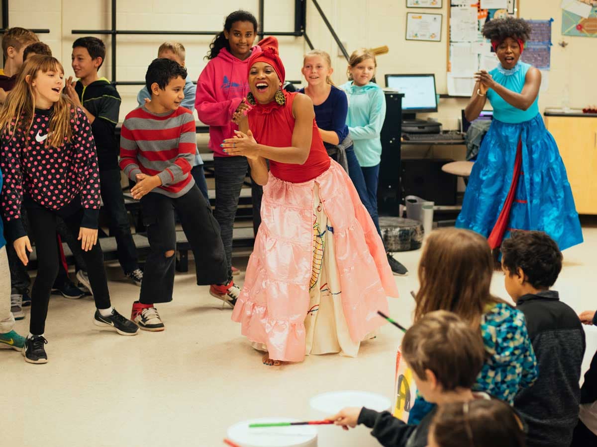 Afoutayi Haitian Dance, Music, and Arts performs in a classroom.